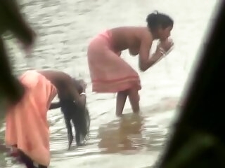 Indian women bathing apart from the river